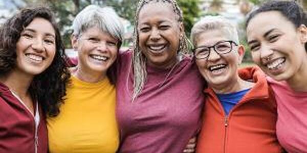 Group of five women smiling